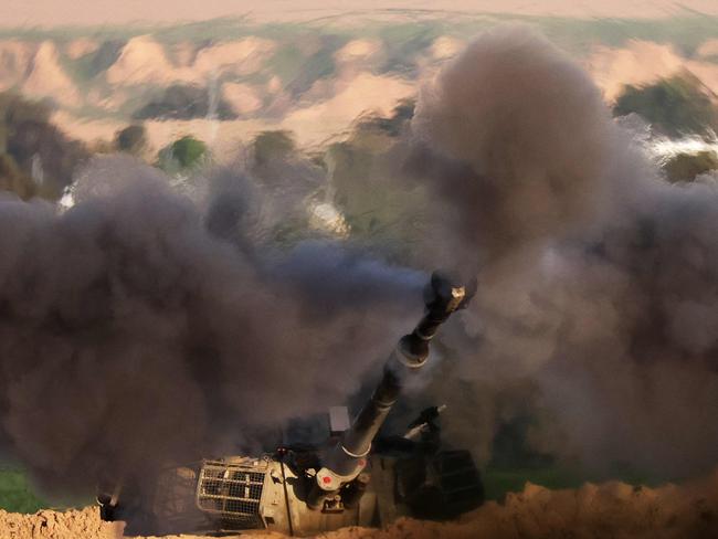 A shock wave is visible as an Israeli army self-propelled artillery fires a round from southern Israel toward the Gaza Strip on February 1, 2024, amid the ongoing conflict between Israel and the Palestinian militant group Hamas. (Photo by JACK GUEZ / AFP)