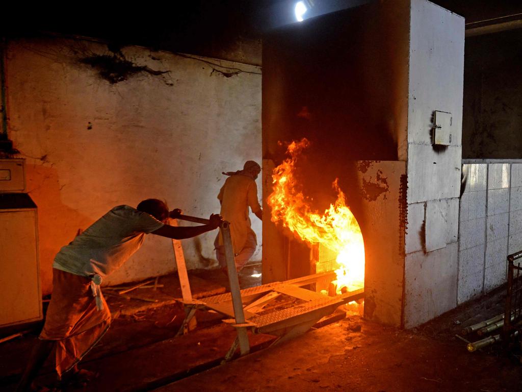 Crematoriums in Delhi are working overtime, burning 100 bodies a day until the ironwork is melting from overuse. Picture: AFP