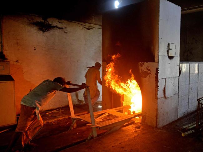 Crematoriums in Delhi are working overtime, burning 100 bodies a day until the ironwork is melting from overuse. Picture: AFP