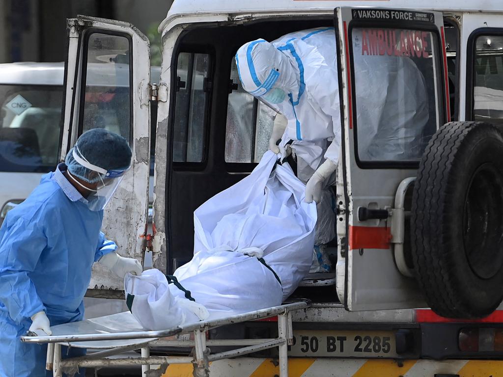 Hospital staff take out a body from an ambulance at a mortuary in New Delhi. Picture: AFP