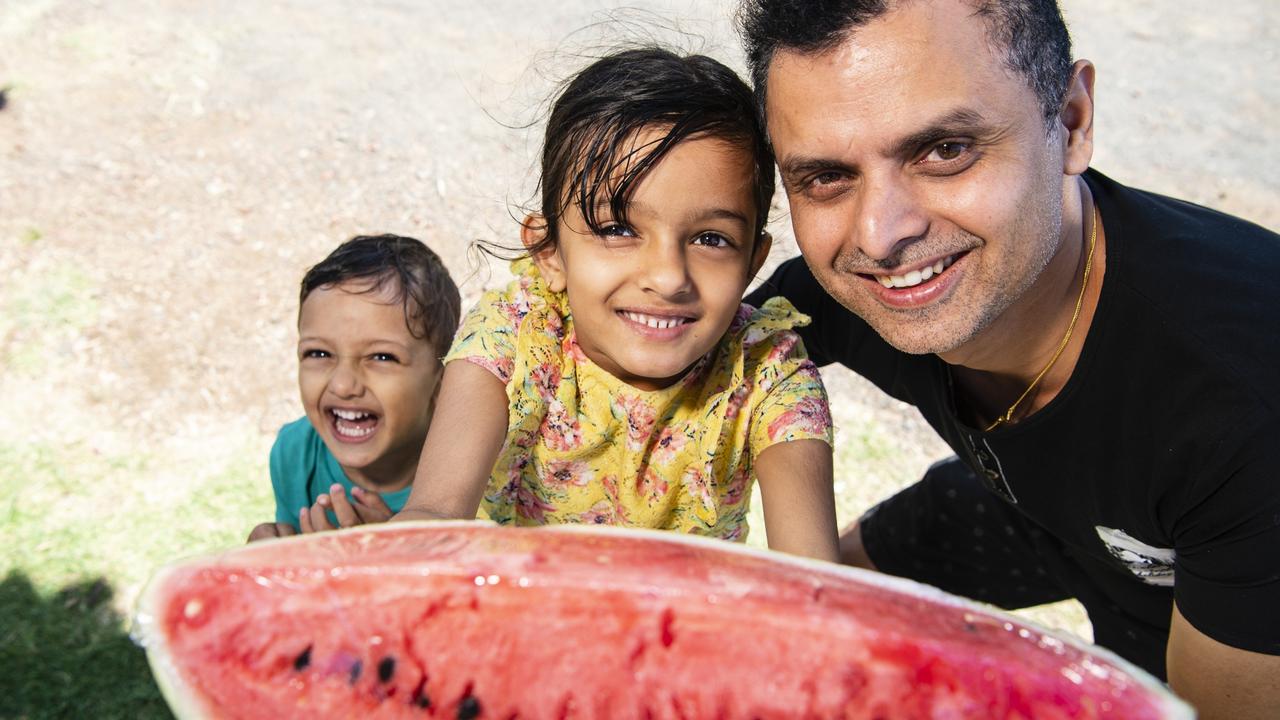 Avishek Khanal with son Amish and daughter Avika Khanal pick up juicy watermelon from the Toowoomba Farmers Markets, Saturday, January 7, 2023.