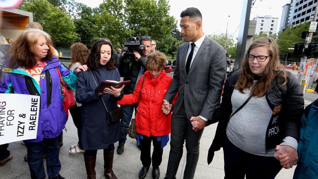 Israel Folau joins in prayer with supporters outside his Federal court mediation with Rugby Australia. Picture: David Geraghty