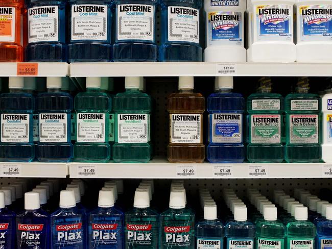 Various types of mouthwash, including Listerine and Plax, stacked on the shelves for sale at Priceline, Broadway, Sydney.