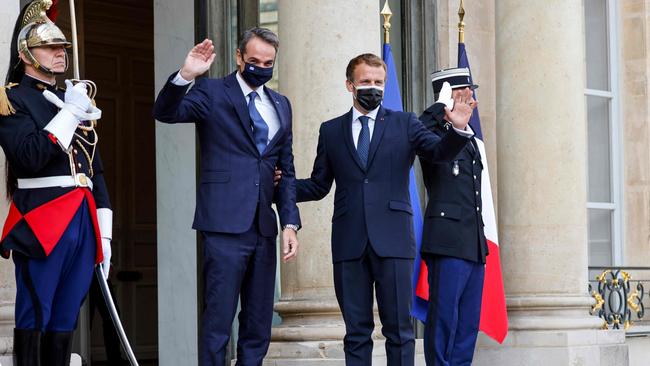 Emmanuel Macron, right, greets Kyriakos Mitsotakis at The Elysee Palace in Paris on Tuesday. Picture: AFP