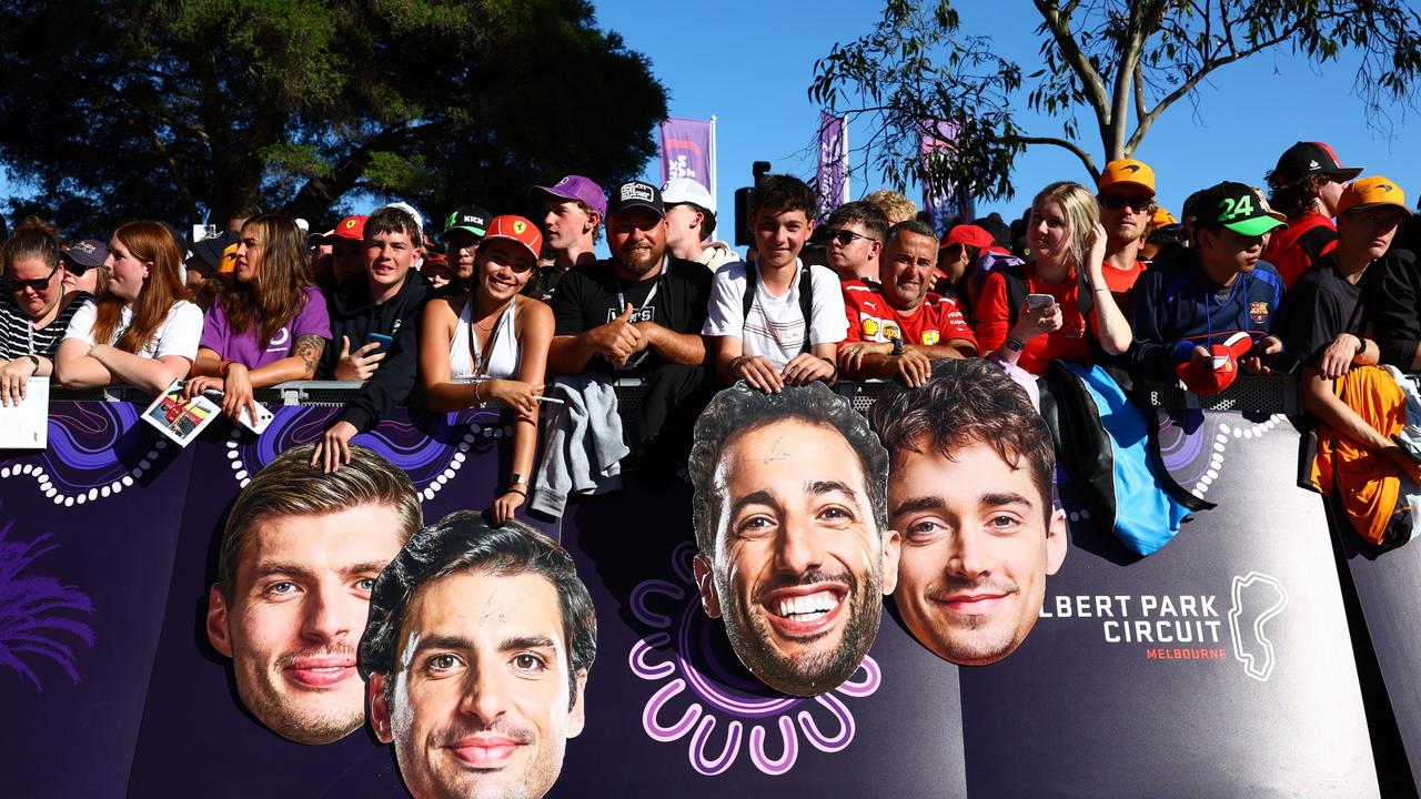 Fans hold cardboard cutouts of Max Verstappen, Carlos Sainz, Daniel Ricciardo and Leclerc. Picture: Mark Thompson/Getty Images