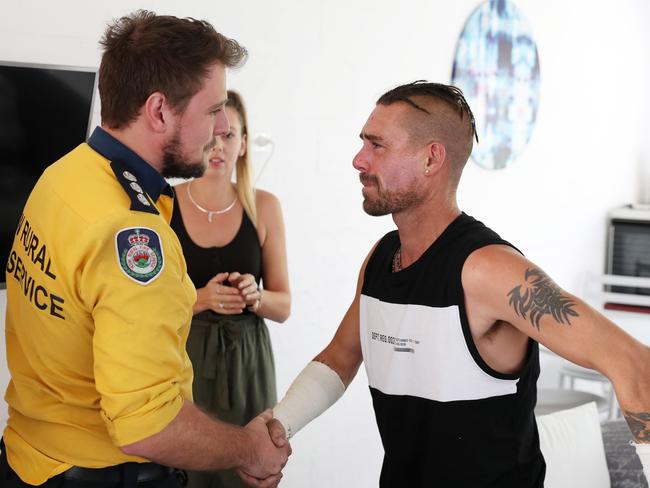 Troy Pauling shakes the hand of RFS firefighter Nathan Barnden. Picture: Jonathan Ng