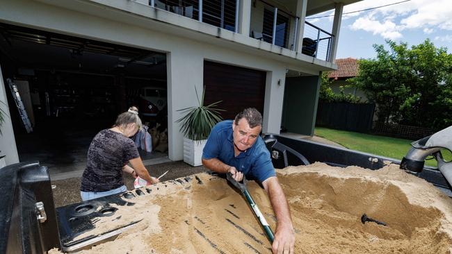 Robbie and Cathy and Cathy Guard work to sandbag their property on the esplanade at Golden Beach on Tuesday in preparation for the approaching Cyclone Alfred. Picture Lachie Millard