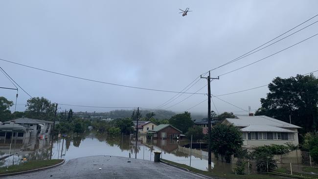 A helicopter flies over flood damage in Hunter Street in Lismore on March 1, 2022.