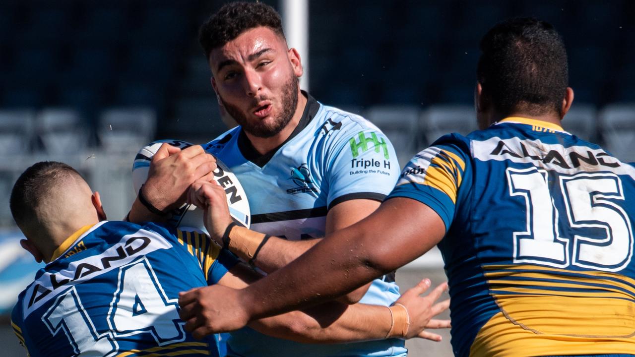 A Cronulla player feels the crunch of a tackle. Picture: Monique Harmer