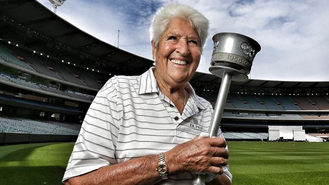 Dawn Fraser on the MCG with the 1956 Olympic torch. Picture: Tim Carrafa