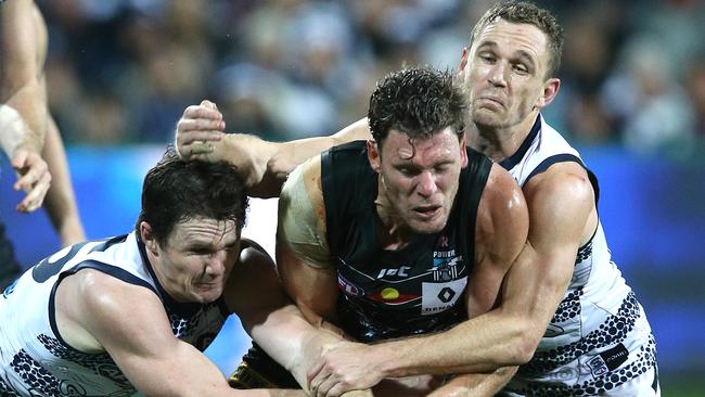 Patrick Dangerfield and Joel Selwood tackle Brad Ebert. Picture: Wayne Ludbey