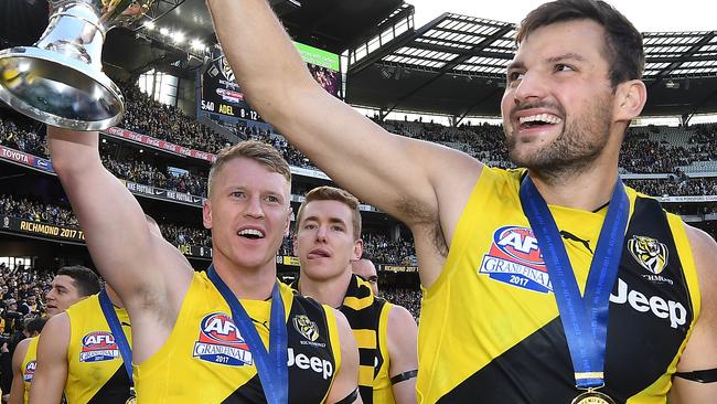 Josh Caddy (left) and Toby Nankervis of the Tigers hold the premiership cup.