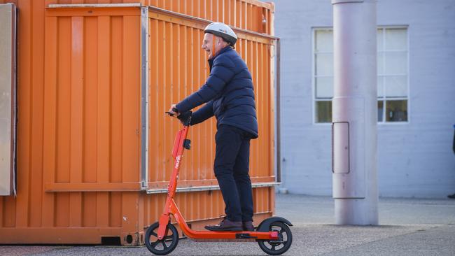 Premier of Tasmania Peter Gutwein rides an electric scooter to a press conference regarding a trial of e-scooters in Hobart, at Princes Wharf No. 1, the day before the 2021 Tasmanian State Election on Saturday 1st May. Picture: NCA NewsWire / Richard Jupe