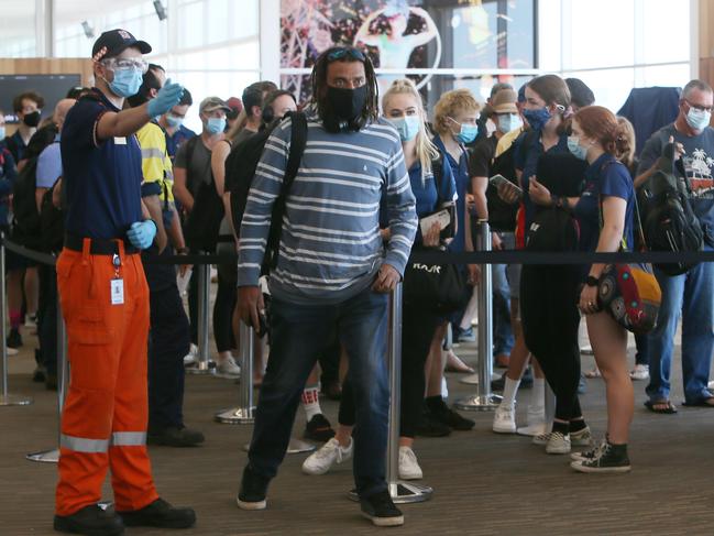 ADELAIDE, AUSTRALIA - NewsWire Photos MARCH 29, 2021: Passengers and Crew arrive at Adelaide Airport and proceed to the COVID-19 processing station after embarking from delayed 12.40pm Brisbane Virgin Flight VA1388. Picture: NCA NewsWire / Emma Brasier