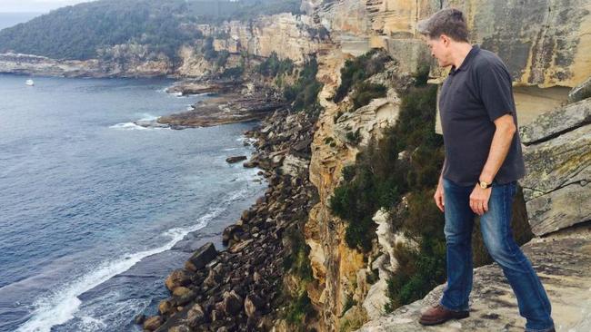 Steve Johnson looks over the cliffs at North Head in Manly in 2016, where his brother Scott's body was found in 1988. Picture: News Corp