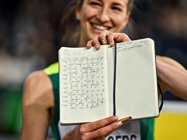 Nicola Olyslagers shows her journal as she celebrates World indoor gold. Picture: Ben Stansall / AFP