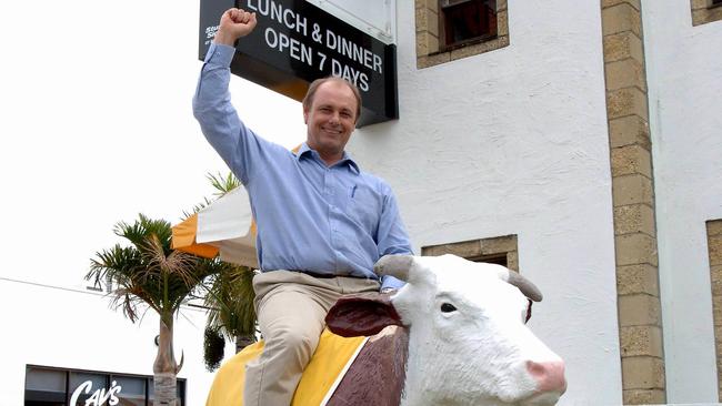 Richard Cavill sitting atop one of the famous cows at Cav's Steakhouse. Picture: Fiona Harding