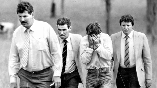 Michael Murphy (second from right) with detectives at a Prospect paddock in 1986. He was one of five men charged and convicted of Anita Cobby’s murder.