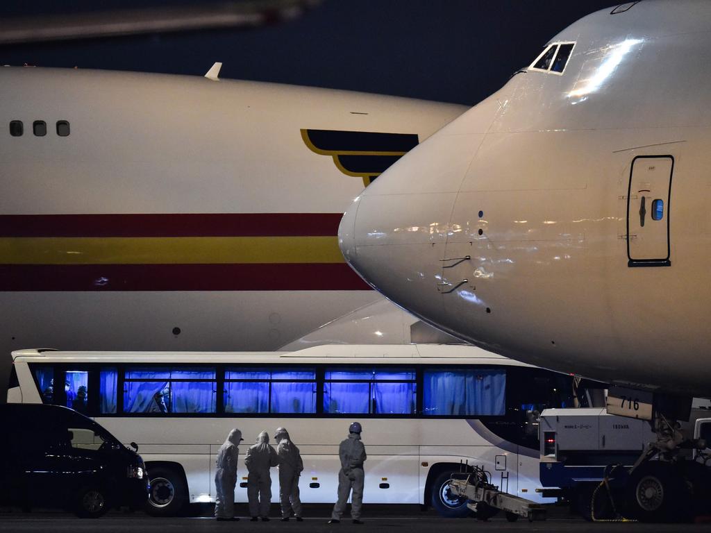 Buses with US passengers on-board arrive at the Haneda Airport, in Tokyo early on Monday after being taken off the Diamond Princess. Picture: Kazuhiro Nogi/AFP