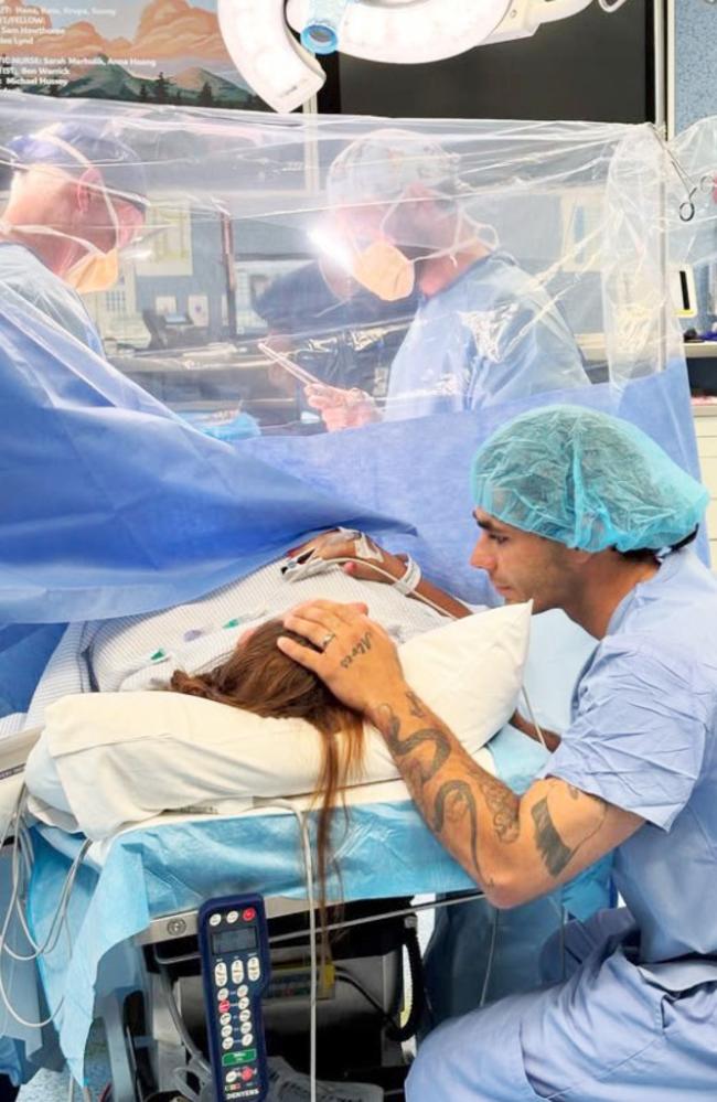 Mathew Alves comforts partner Keely Walsh as she gives birth to identical triplets. Picture: Supplied