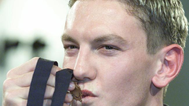 Shane Woewodin kissing the Brownlow Medal in 2000.