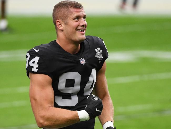 (FILES) In this file photo Carl Nassib #94 of the Las Vegas Raiders flexes while smiling during warmups before a game against the Denver Broncos at Allegiant Stadium on November 15, 2020 in Las Vegas, Nevada. - Las Vegas Raiders defensive end Carl Nassib made history on June 21, 2021, after coming out as the first active openly gay player in the NFL, announcing his sexual orientation in a post on social media.  The 28-year-old five-year veteran said in a video posted on Instagram he hoped his example would boost visibility of other gay athletes. (Photo by Ethan Miller / GETTY IMAGES NORTH AMERICA / AFP)