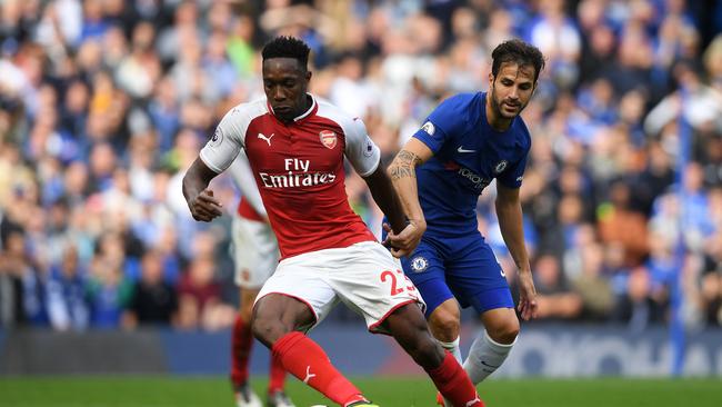 Danny Welbeck of Arsenal attempts to get away from Cesc Fabregas.