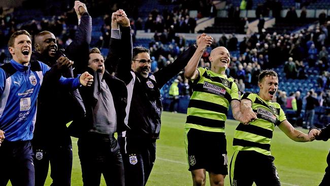 Aaron Mooy celebrates with Huddersfield Town teammates.