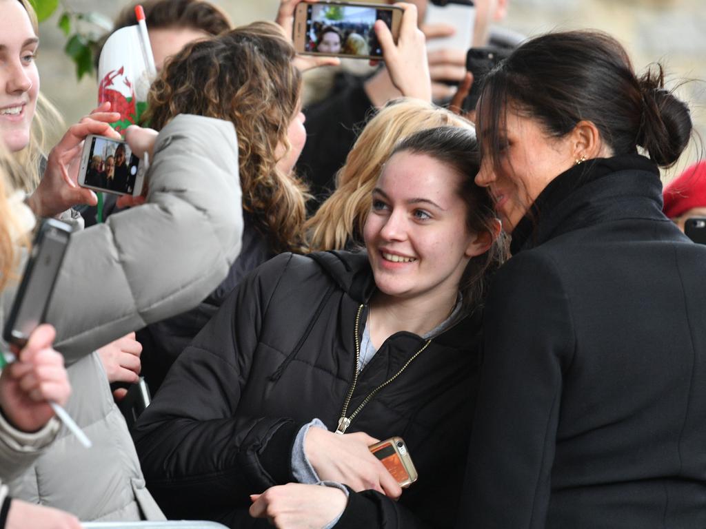Meghan was happy to oblige a young fan by posing for a selfie in Cardiff. Picture: Splash News