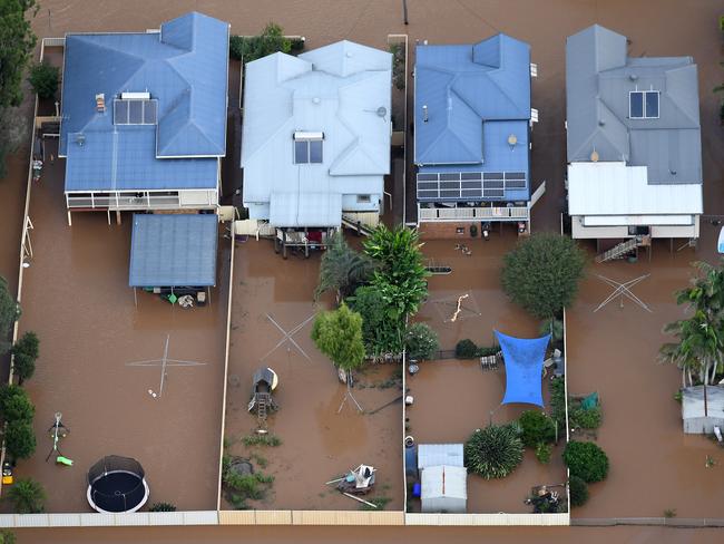 An aerial photograph of floodwaters engulfing homes in central Lismore last Friday. Picture: Dave Hunt / AAP