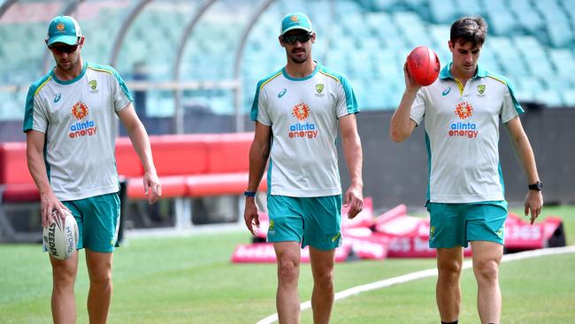 Josh Hazlewood, Mitchell Starc and Pat Cummins. (Photo by Saeed KHAN / AFP)