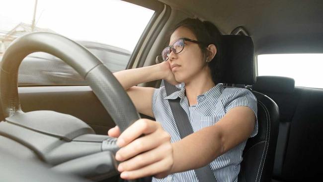 Asian glasses woman boring bad traffic jam on rush hours, Business woman driving a car. exhausted, tired for overworked concept. Picture: eggeeggjiew