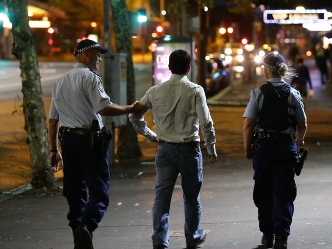 Police move along a male who was ejected from Scruffy Murphy's Pub. Generic images of George Street, Sydney CBD. The area is notorious for street violence and crime. The area where most of the incidents occur is, Scruffy Murphys Pub on Golburn Street, McDonalds Restaurant on George Street, Hungry Jacks on George Street and the Three Wise Monkeys on George Street. Pics Bill Hearne Picture: Hearne Bill