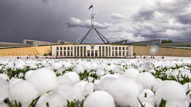 The Australian Weather Calendar 2021: Hail blankets the lawns of Parliament House, Canberra. Picture: David Foote