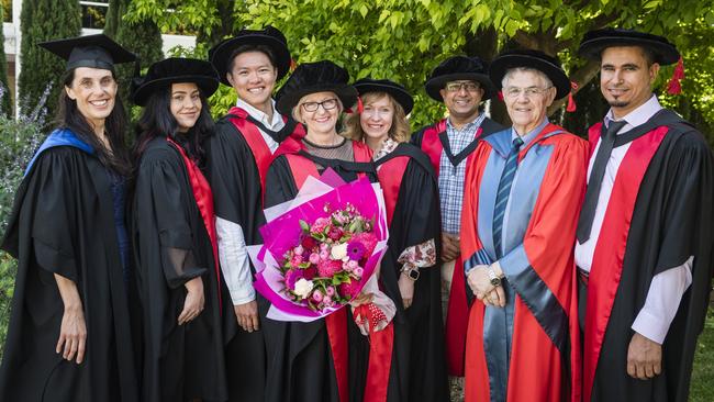 UniSQ School of Health and Medical Sciences staff (from left) Helena King, Dr Nikita Walz, Dr Lin Ong, PhD graduate Dr Leanne Dooley, Prof Eliza Whiteside, Dr Prajwal Gyawali, Prof Mike Kotiw and Dr Tarek Ahmad show their support for Dr Dooley at her graduation ceremony at Empire Theatres, Tuesday, October 31, 2023. Picture: Kevin Farmer