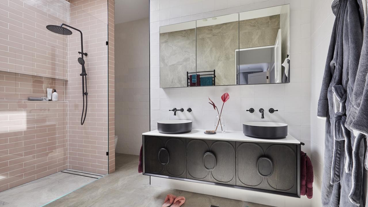 Black accents continued in the bathrooms with a statement pink tile.