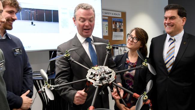 Defence Industry Minister Christopher Pyne with staff from defence technology manufacturer Lockheed Martin in Melbourne. AAP Image/Joe Castro