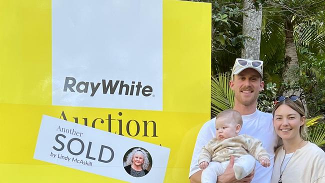 REAL ESTATE: Jordie Hansen and Sam Frost with baby, Ted, pose for a photo after buying a Doonan home at auction. Image supplied by Ray White.