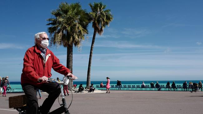 A man cycles on the Promenade des Anglais, in Nice. Picture: AFP.