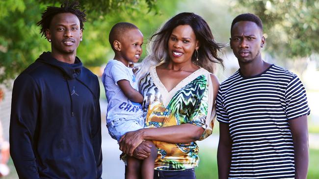 Aluel Kuol with sons, from left, Bolis Daw, 18, three-year-old Aleu Deng and Deng Daw, 23. Picture: Aaron Francis