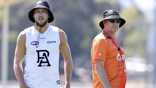 Ken Hinkley walks past Cameron Sutcliffe during pre-season camp at Maroochydore. Picture: Sarah Reed