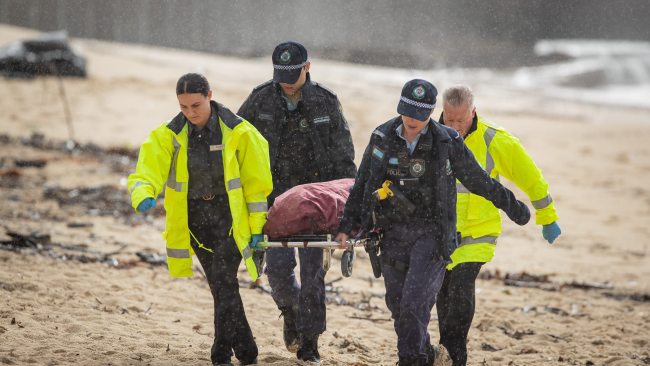 Police officers carry the woman's remains off Bronte Beach on Wednesday morning. Picture: Daily Telegraph/ Julian Andrews.
