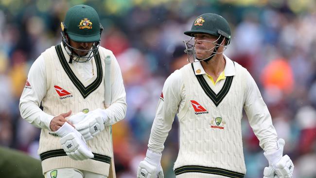 Usman Khawaja and David Warner walk off the field for lunch. Picture: Getty Images.