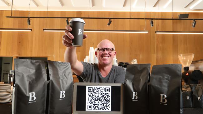 Blackboard Varsity general manager Wayne Keating with a QR Code system to electronically store your details when you wish to dine in for breakfast and coffee. Picture: Glenn Hampson