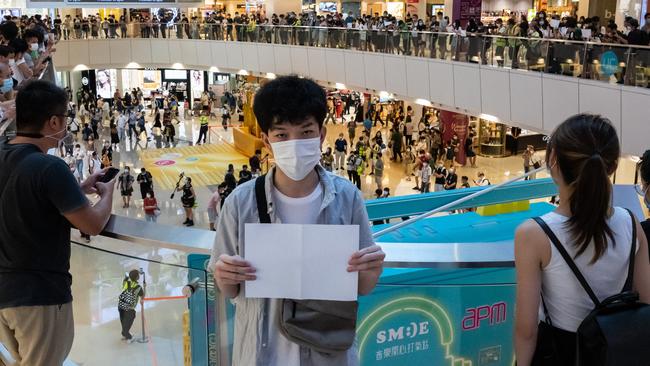 A protester holds up a blank paper during a demonstration in a Hong Kong mall on Monday. Picture: Getty Images