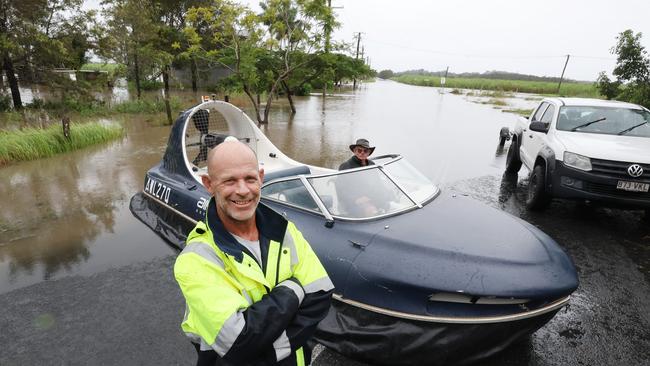 Flooding on the Gold coast in the aftermath of Cyclone Alfred. Stapylton homes surrounded by floodwaters..Tony Bailey from Airlift Hovercraft , uses one to check on the welfare of his neighbours. Picture Glenn Hampson