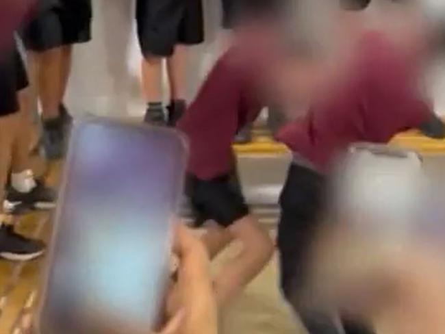 More than a dozen students at an Adelaide high school have been suspended after organising and filming a brawl at lunchtime., A video shows two boys going toe-to-toe in a fight at Underdale High School yesterday in the school's sports sheds while dozens of other students watch on and film it. Picture: Nine News