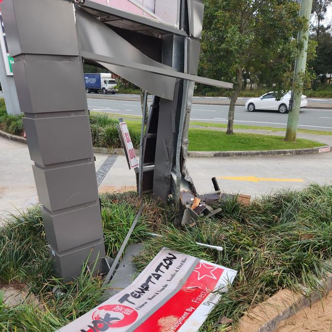 The aftermath of the crash into the sign of Boonooroo Park Shopping Centre at Carrara. Picture: Tom Boswell