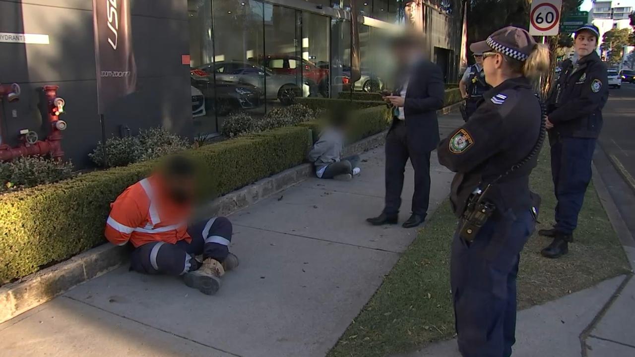 Strike Force Raptor police detain two men while investigating the drugs and weapon ring in Sydney. Picture: NSW Police.