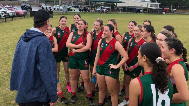 The Sandgate girls listen to an address from their coach Shane Watterson.